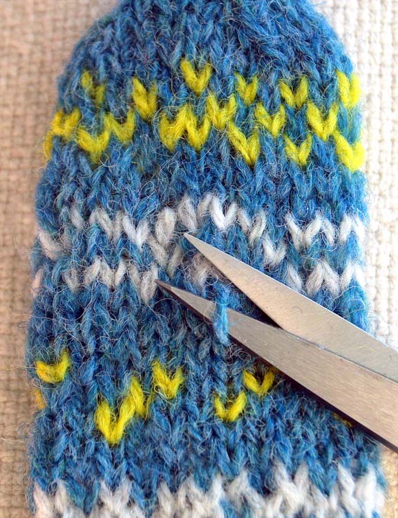 image of blue and yellow knitting with stitch to snip