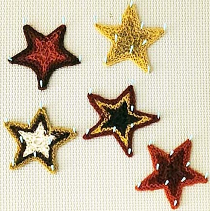 knit stars pinned and blocked on background