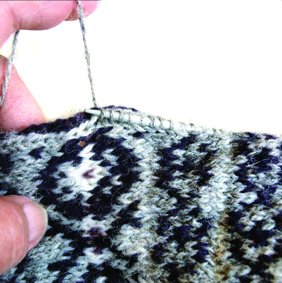 swatch of knitting up with fair isle