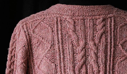 shoulder saddle on a pink aran knitted sweater