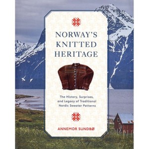 cover of the book Norway's Knitted Heritage with mountains in background and vintage cardigan with white buttons on cover