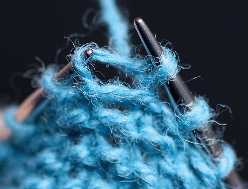 Close up of increasing technique, blue wool on needle tips