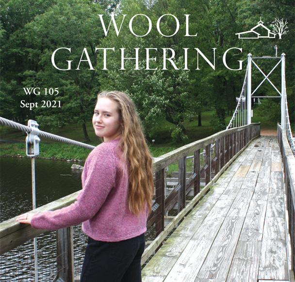 Wool Gathering booklet cover with Issue 105 and September 2021, woman in pink raglan on suspension bridge over river