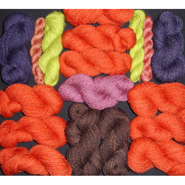 hand dyed yarns in bright colors oranges and purples and pinks