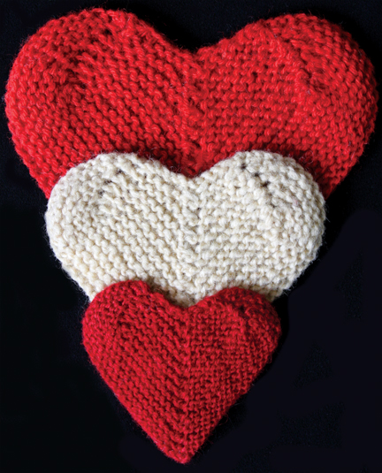 Three knitted hearts red and cream