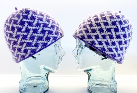 hats on glass heads in same colors but showing difference in color based on shifting the light and dark when knit