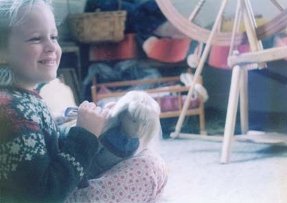 close up of blonde girl with blonde haired doll