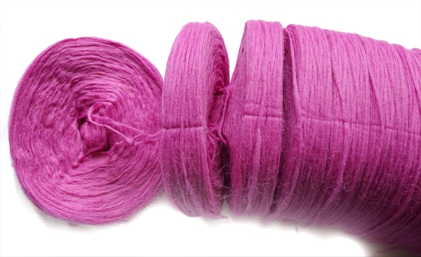 breaking apart bun of pink unspun icelandic wool 