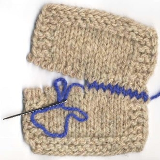 two pieces of natural wool being joined using contrasting blue yarn