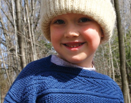 little boy in a guernsey sweater and hat