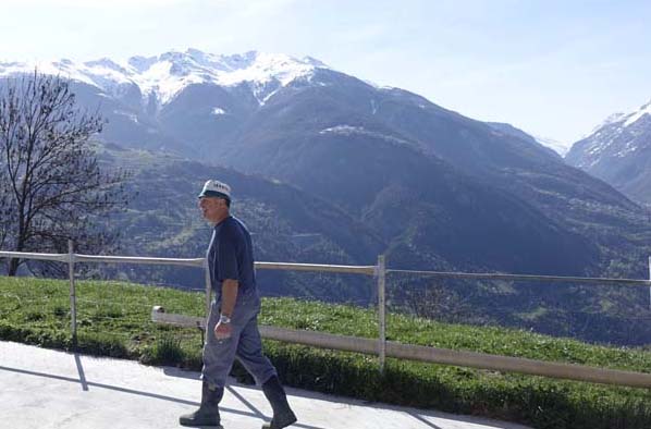 a farmer walking down a road in Italy